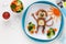 Cute smiling monkey shaped burger with vegetables for kids