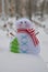 Cute snowman handmade toy in the snow