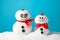 Cute snowmans with red bow on blue background