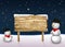 Cute Snowmen with a blank wooden sign