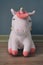 Cute soft unicorn plush toy on the floor. Close up shot