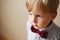 Cute solemn little boy wearing a bow tie