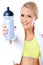 Cute sporty blond woman holding water bottle