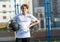 Cute sporty teenage boy in white t shirt plays basketball outdoors preparing for shooting. healthy sport lifestyle