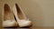 Cute stylish beige high heels on the background room, glamor, fashion, wedding