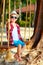 Cute stylish boy on swings on the beach