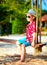 Cute stylish boy on swings on the beach