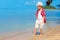 Cute stylish boy walking the tropical beach