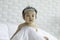 Cute Sweet Adorable Asian Baby wearing bride dress and diadem Sitting on white bed