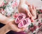 Cute sweet female pink baby shoes in hands