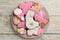 CUte tasty cookies of different shapes on white wooden table, top view. Baby shower party