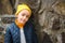 Cute teen boy close up portrait. Stylish boy wearing yellow hat and jacket. Autumn fashion, copy space. Outdoors portrait of cute