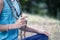 A cute teen girl with blonde hair chants a mantra on a rosary. Yoga, spirituality concept