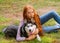 Cute teen girl with red long hair walks with her husky breed dog in the autumn park. Children and dogs.