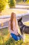 Cute teen girl with red long hair walks with her husky breed dog in the autumn park. Children and dogs.