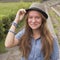 Cute teen girl wearing a hat, outdoors in the park