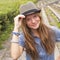 Cute teen girl wearing a hat, outdoors in the park