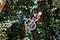 Cute teen jumping with his bike over a natural ramp in the fores