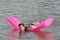 Cute teenage girl lying on the pink mattress