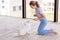 Cute teenage girl training her spitz dog at home