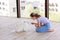 Cute teenage girl training her spitz dog at home