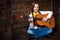 Cute teenager cowgirl plays the guitar