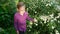 Cute teenager girl walking and touching on camomile field top view top-down