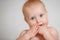 Cute Teething Infant Hold Fingers By Mouth Closeup