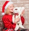 Cute and tender gift. Woman santa hat hug soft toy bear. Best gift ever. Girl happy celebrate new year christmas