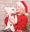 Cute and tender gift. Woman santa hat hug soft toy bear. Best gift ever. Girl happy celebrate new year christmas