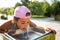 Cute thirsty girl drinks water from drinking sink