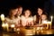 Cute thirteen years old girl making a wish before blowing candles on her birthday cake. Family of five celebrating childs birthday