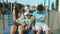 Cute three siblings riding on swing outdoor. Adorable kids spending time in park