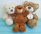 Cute three teddy bear toy with red box on colored wooden, family