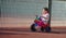 Cute three-year-old little child riding a 3-wheel bike in playground