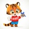 Cute tiger cub in red christmas sweater holding milk and cookies on a platter on a white background