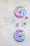 Cute toasts with colorful cream cheese spread on a light grey stone background. Ideas for kidâ€™s food.