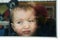 Cute toddler baby boy close up portrait with flat nose agains the window
