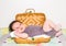 Cute toddler baby resting in the small wooden travel suitcase