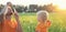 Cute toddler blond boy playing with soap bubbles on summer field. Happy child summertime concept. Authentic lifestyle image