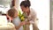 Cute toddler boy carries a bouquet of yellow tulips to his mother. Indoor portrait. Mother and son celebrating mothers