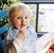 Cute toddler boy eating pasta in Italian indoors restaurant