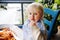 Cute toddler boy eating pasta in Italian indoors restaurant