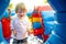 Cute toddler boy jumping on a inflatable bouncer in a backyard on warm and sunny summer day. Sports and exercises for children