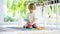 Cute toddler boy playing with lego blocks construction set on the floor at home