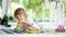 Cute toddler boy playing with lego blocks construction set on the floor at home