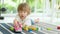 Cute toddler boy playing with lego blocks construction set on the floor at home