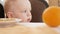 Cute toddler boy sitting in cafe and waiting for food. He reviews the visitors around