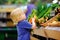 Cute toddler boy in supermarket choosing fresh organic carrots