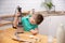 Cute toddler boy using hand blender to make minced meat. Preparing meal in the kitchen